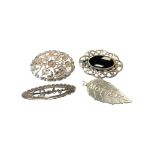 Four decorative silver brooches