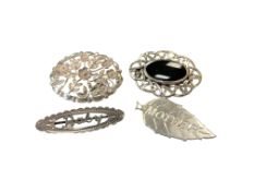 Four decorative silver brooches