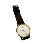 An 18ct yellow gold Gentleman's Baume & Mercier wristwatch with brown leather strap,