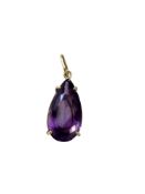 A large amethyst pendant mounted in gold