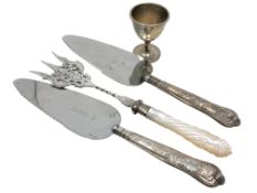 A Victorian silver egg cup and three items of silver mounted cutlery including toasting fork