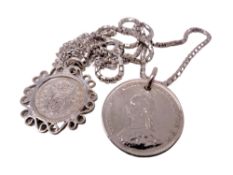 An 1887 shilling and further coin on chain