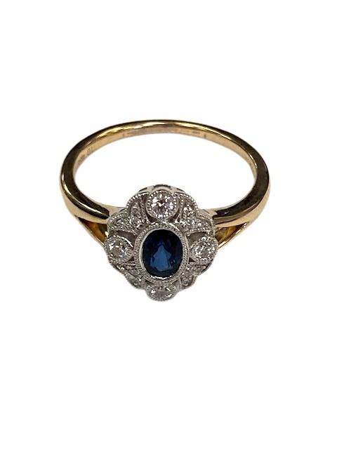 A 9ct gold diamond and sapphire cluster ring, millgrain set 0.