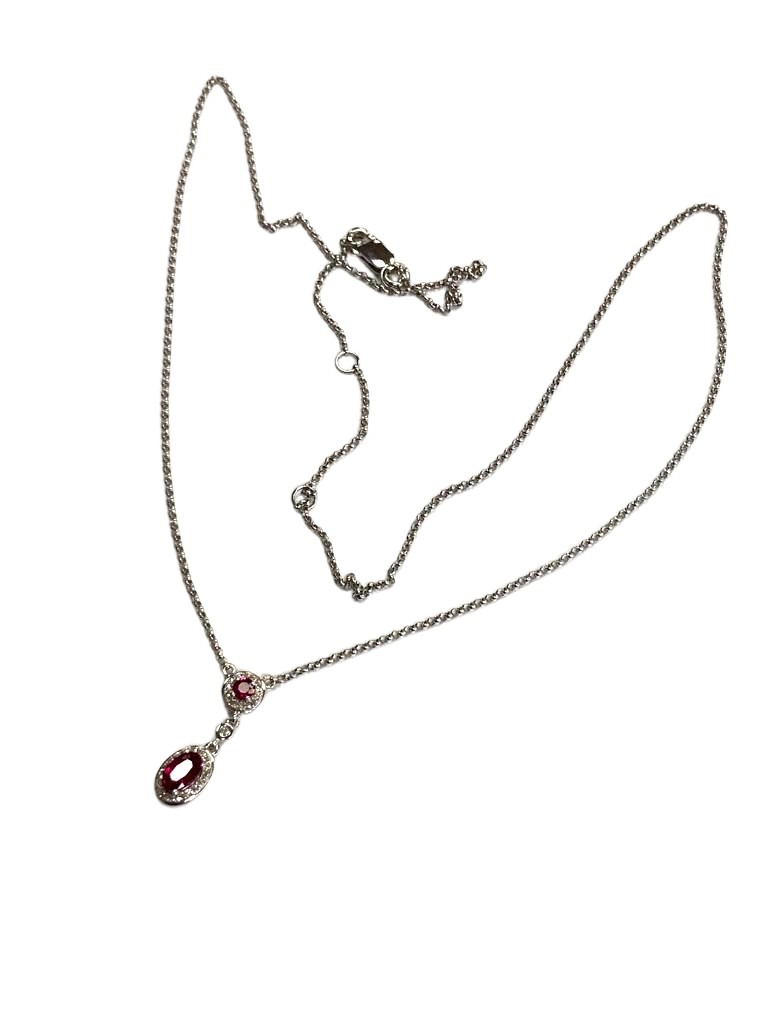 A 9ct white gold ruby and diamond pendant, the ruby approximately 0.45ct.