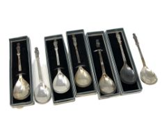 A collection of seven silver apostle spoons each showing a different saint (five boxed)