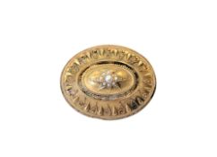 An antique gold circular brooch