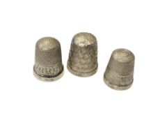 Three silver thimbles