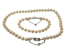 A costume pearl necklace with matching bracelet