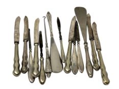 A collection of silver handled cutlery, button hooks,