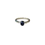 A platinum sapphire and diamond three stone ring, size L.