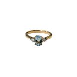 A 9ct white gold three stone diamond and aquamarine ring, size M.