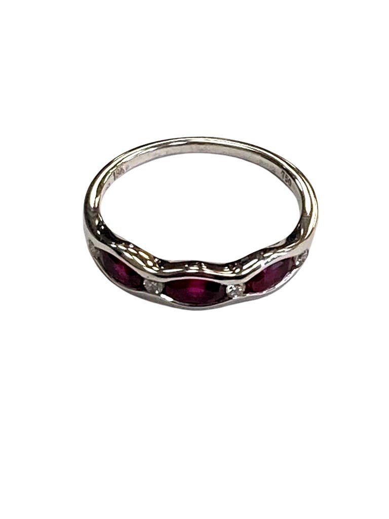 An 18ct white gold ruby and diamond band ring