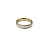 A 9ct white gold band ring with yellow gold millgrain edge, size K/L, 3.8g.