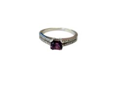 An 18ct white gold ruby and diamond ring, size M.