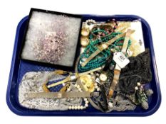 A collection of costume jewellery and wrist watches.