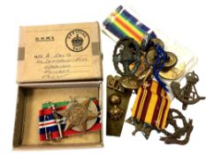 A collection of war medals and badges including Atlantic Star,