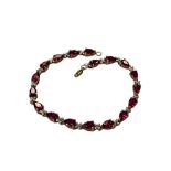 A gold simulated ruby bracelet CONDITION REPORT: 7.