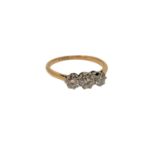 An 18ct gold three stone diamond ring, size M CONDITION REPORT: 2.