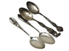 Four highly decorative American silver spoons depicting scenes of California.