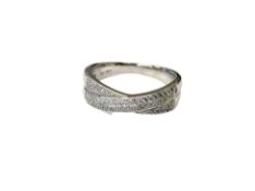 An 18ct white gold diamond set cross over band ring, size O/P.