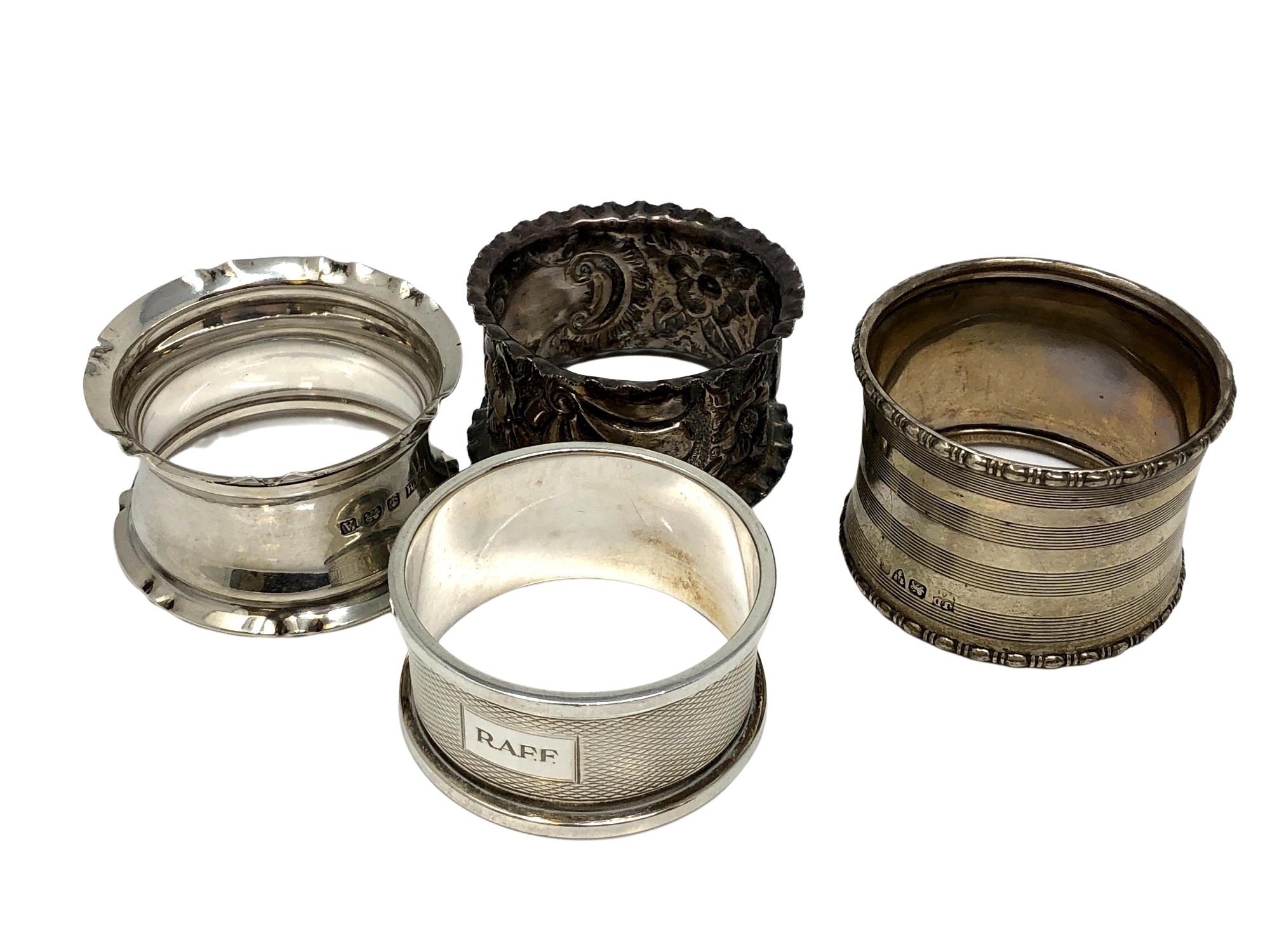 Four assorted silver napkin rings CONDITION REPORT: 68.
