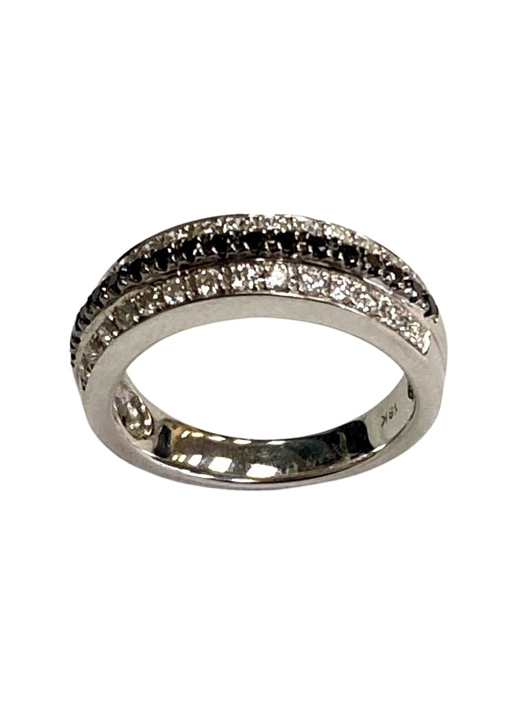 An 18ct white gold black and white diamond ring