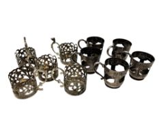 Two sets of five antique silver cup holders.