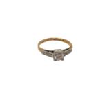 An antique 18ct gold diamond solitaire ring with diamond set shoulders,