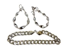 A silver bracelet with earrings