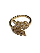 An 18ct gold diamond leaf design ring, size L/M.