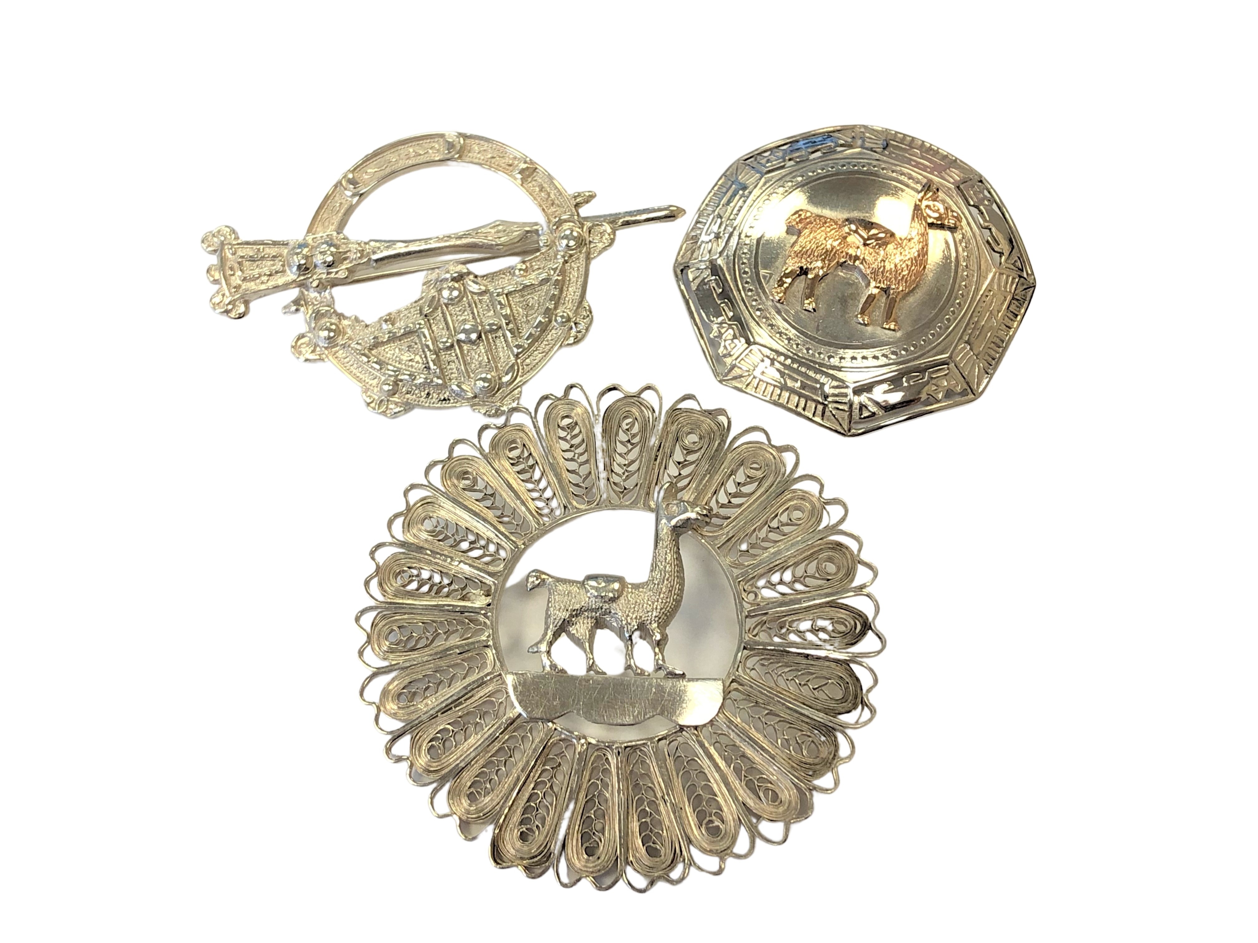 Three silver brooches