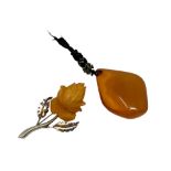 An amber pendant and an .835 silver mounted brooch stamped SBM.