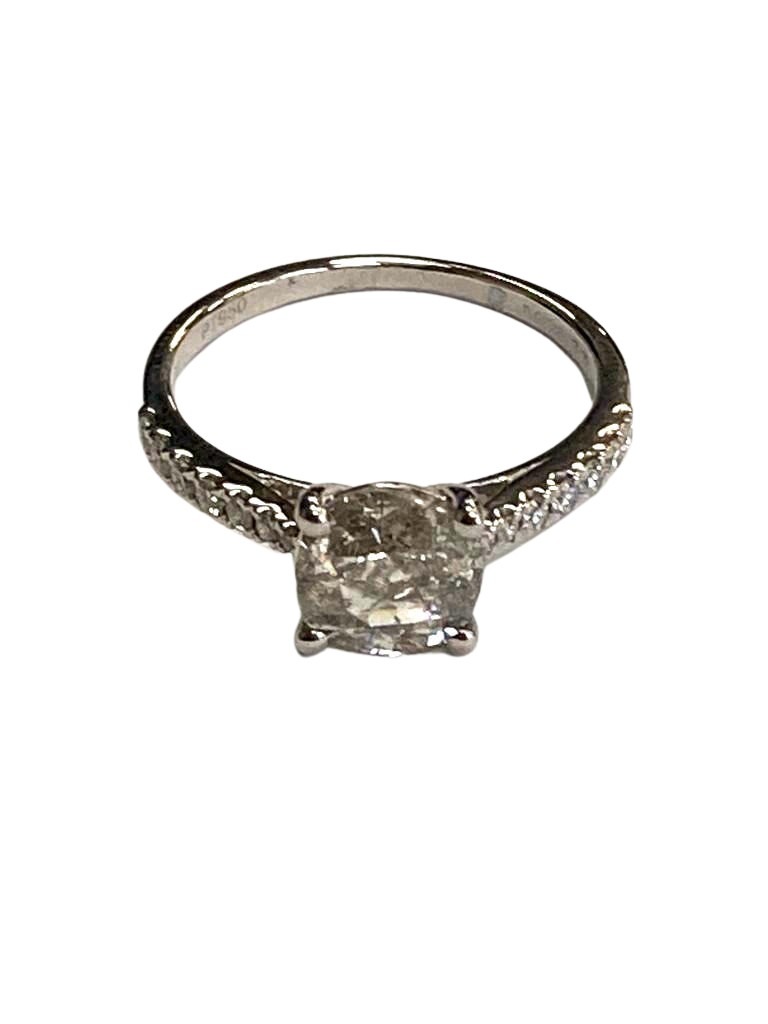 A platinum diamond solitaire ring, set with diamond shoulders,