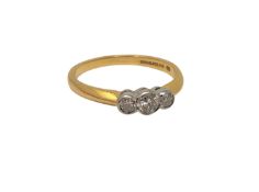 An 18ct gold three stone diamond ring, stated total diamond weight .