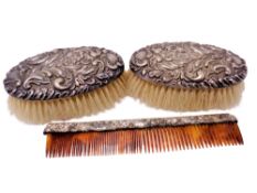 Two silver backed brushes and a silver mounted comb