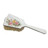 A silver and floral enamel dressing table brush