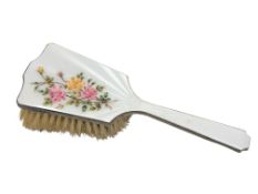 A silver and floral enamel dressing table brush