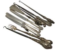 A group of silver mounted button hooks, silver handled knives,