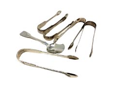 Five pairs of Georgian/William IV sugar tongs and a spoon,