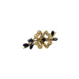 An 18ct gold diamond and sapphire brooch, 7.2g, width 38 mm.