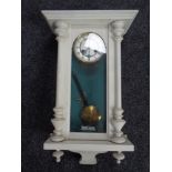 An early 20th century painted Junghans eight day wall clock with pendulum and key