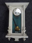 An early 20th century painted Junghans eight day wall clock with pendulum and key