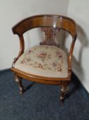 A walnut elbow chair with embroidered seat