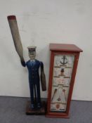 A reproduction folk art wooden weather vane in the form of a sailor,