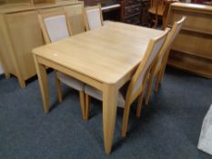 An Ercol Artisan extending dining table and four matching chairs