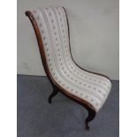 An antique nursing chair in Regency style fabric