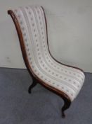 An antique nursing chair in Regency style fabric