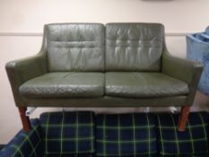 A mid 20th century Scandinavian two seater settee in green leather