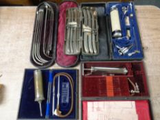 A tray of five cases of medical instruments and syringes