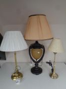 A contemporary ornate table lamp with shade and two further table lamps